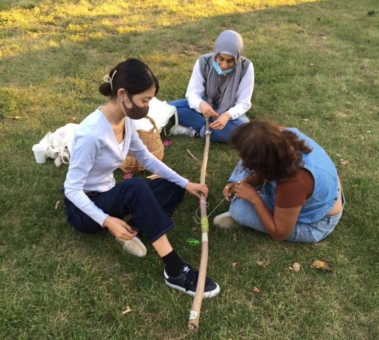 Story stick wrapping with yarn with 3 community participants
